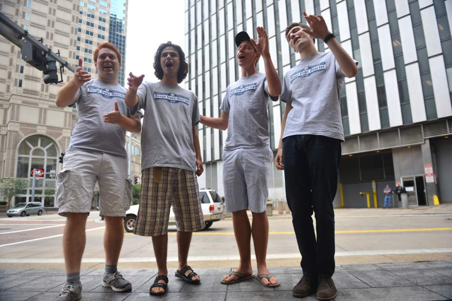 The Yonge Guns Quartet from Toronto, Ontario, Canada (from left) Chris Tanaka-Mann, Reuven Grajner, Greg Mallett and Jonah Lazar perform 'If My Friends Could See Me Now/Hey Look Me Over' medley Tuesday June 30, 2015 on a park bench along Liberty Avenue in Downtown Pittsburgh. Read more: http://triblive.com/aande/music/8652964-74/harmony-barbershop-convention#ixzz3eddKzqig   Photo: James Knox | Trib Total Media